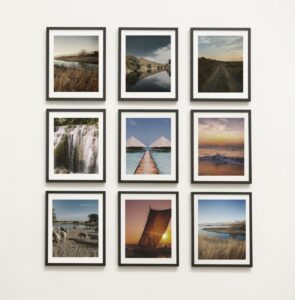 3 rows of scenic photos on a wall in black frames