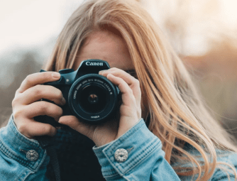 Woman taking photo facing camera