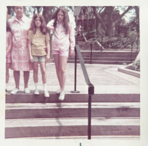 Young girls in the 1970s standing on a steps outdoors
